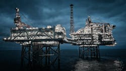 Offshore oil and gas platform at night
